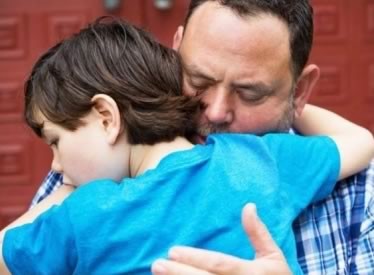 Boy embracing his father Boy embracing his father