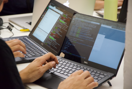 Two participants working shoulder to shoulder in the Rarehacks event