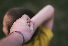 Adult and child holding hands