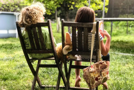 Siblings sitting on a backyard