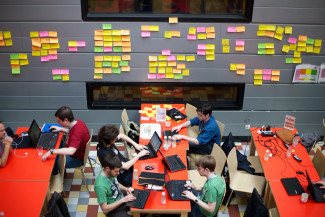 Many people working on their laptops in the same space