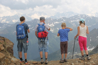 Parents and two children on the top of a mountain