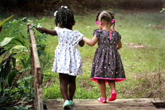 Two girls holding hands on the countryside Inflammatory Myofibroblastic Tumors