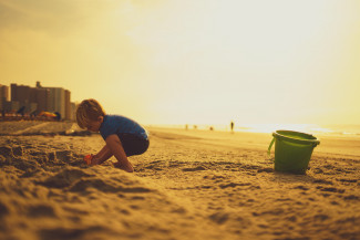 Can children get melanoma A child playing on the beach under the sun