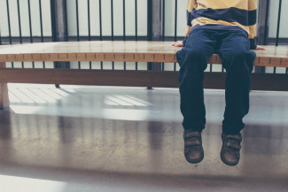 Boy sitting on a bench