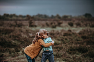 Siblings and rare diseases Girl and boy hugging on the countryside