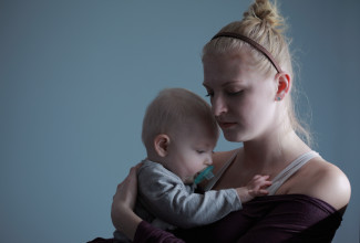 Worried mother holding a baby