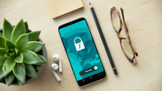Digital CI Share4Rare Cell phone locked with cactus, headphones and glasses