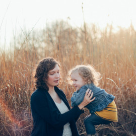 Caption of Sheonad Macfarlane playing with her child, a girl suffering SMA